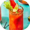 Colorful cocktail with lime and celery garnish.