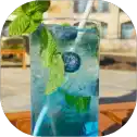 Blueberry mint cocktail with a straw.