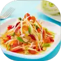 Spicy papaya salad on a white plate.