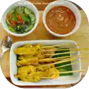 Chicken satay with peanut sauce and salad.