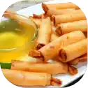 Spring rolls with dipping sauce on plate.