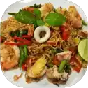 Seafood noodles with vegetables and lime garnish.