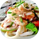 Seafood salad with vegetables on a plate.